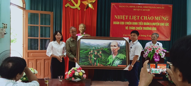 Đồng chí Nguyễn Văn Nguyên – Nguyên chính trị viên tiểu đoàn 8 đại diện tặng ảnh “ Bác vẫn cùng chúng cháu hành quân” cho Đảng uỷ, HĐND, UBND, UB MTTQ xã.